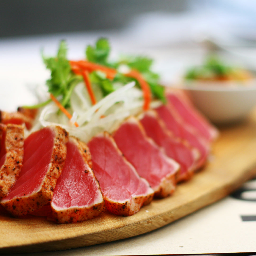 Seared Ahi tuna Niçoise salad with green beans, cherry tomatoes, Kalamata olives, hard-boiled eggs, and Dijon vinaigrette