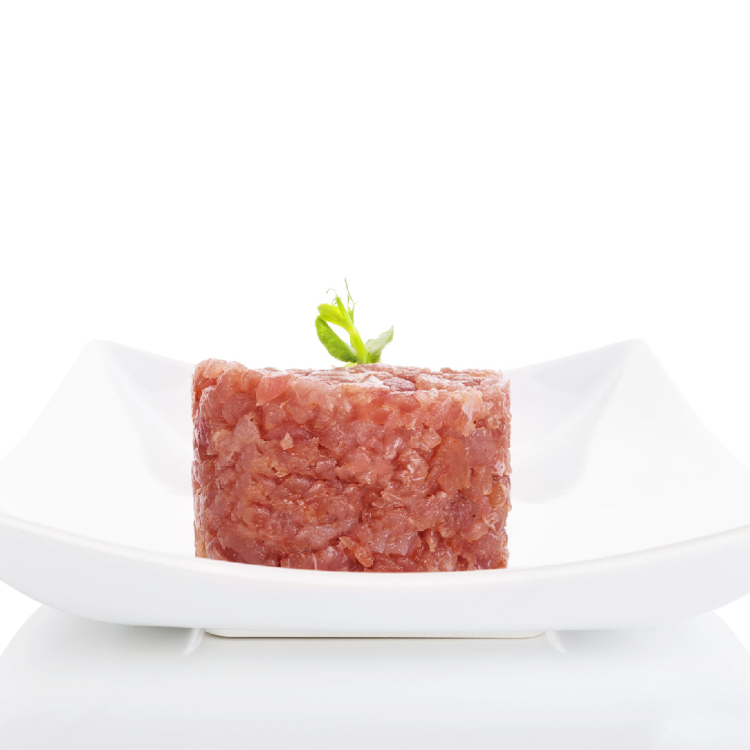 Seared Ahi tuna sliced over Romaine Caesar salad with Parmesan, croutons, and lemon wedges