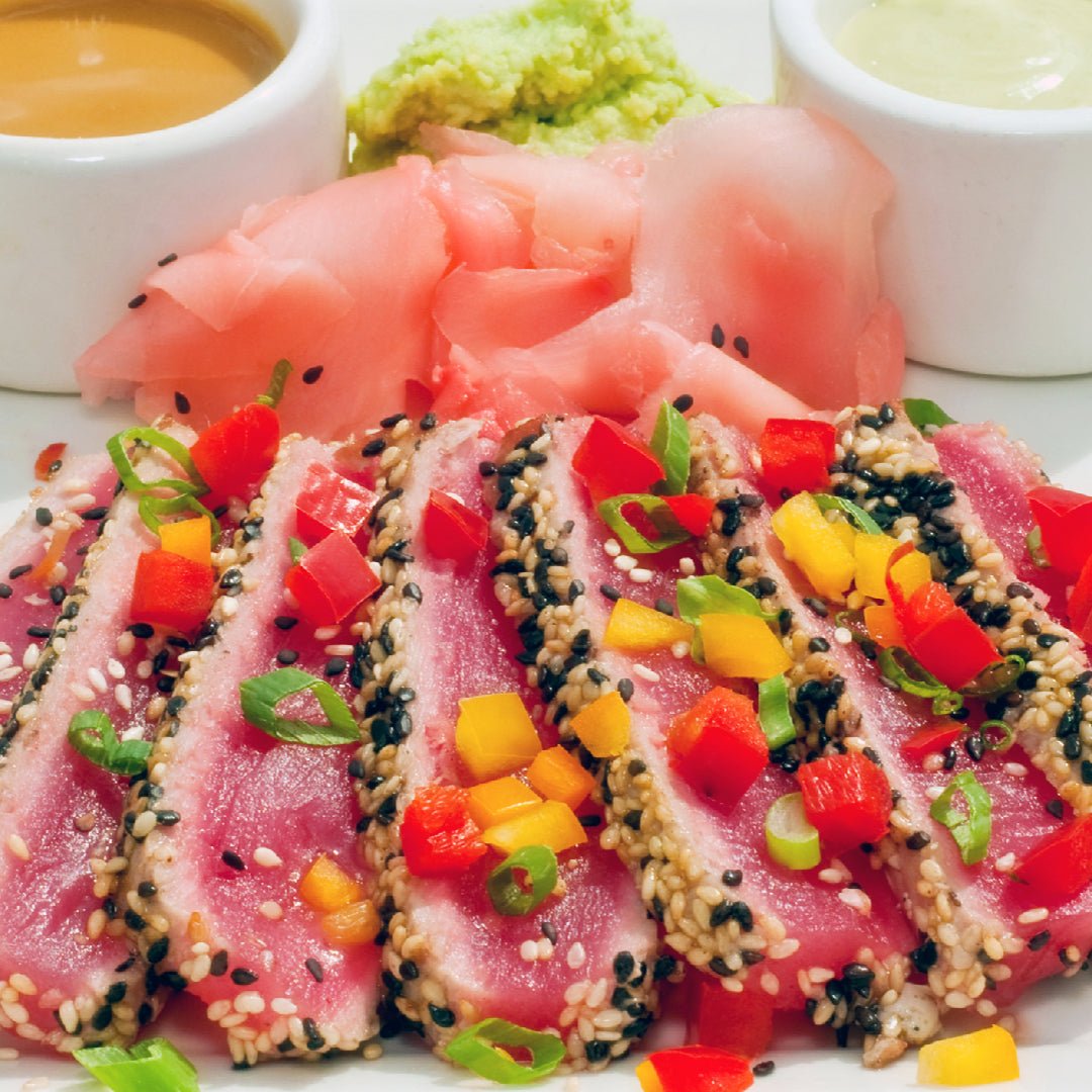 Golden crispy Ahi tuna croquettes on a plate with lemon-mayo dipping sauce, garnished with fresh parsley and lemon wedges