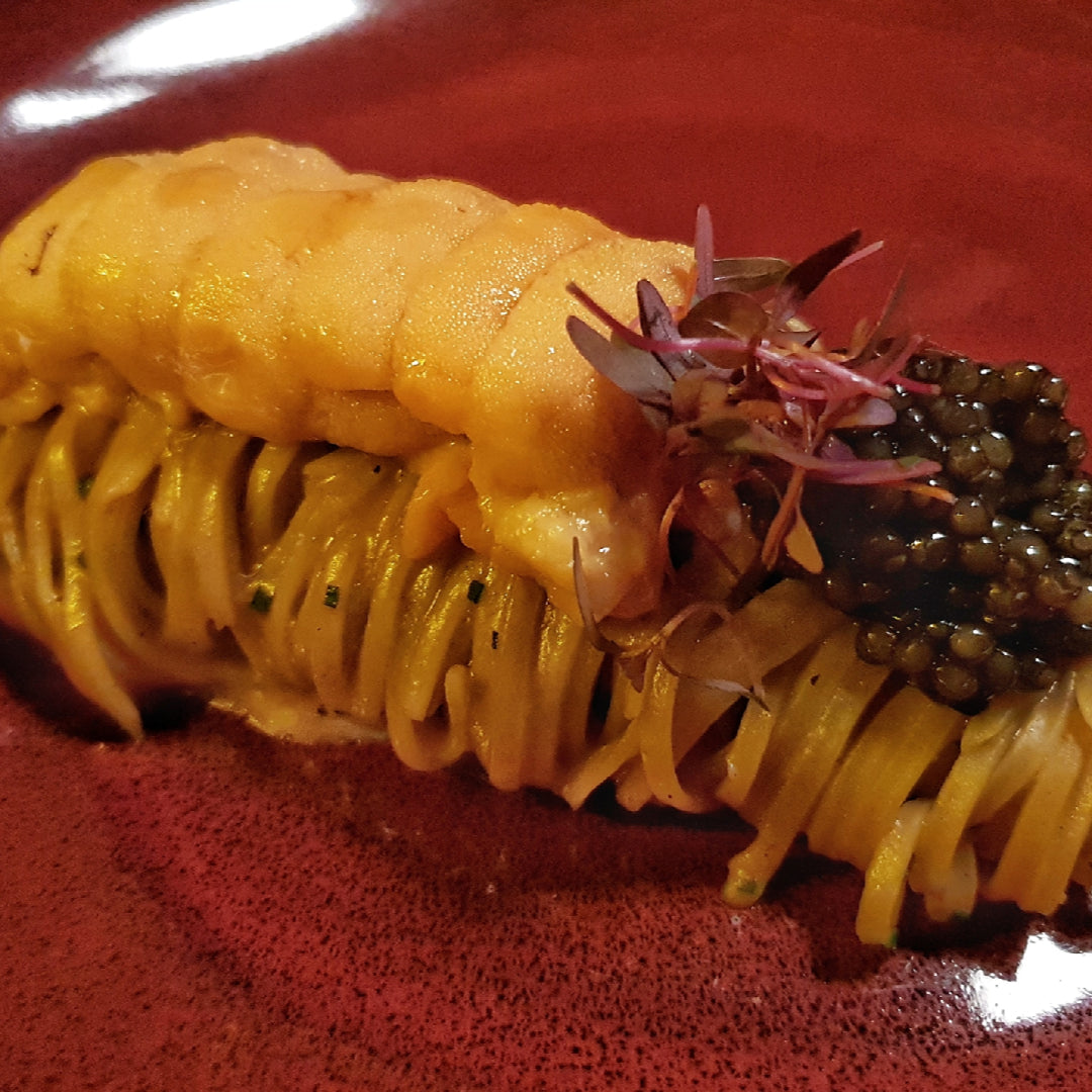 Fresh sea urchin uni on a wooden board ready for sushi