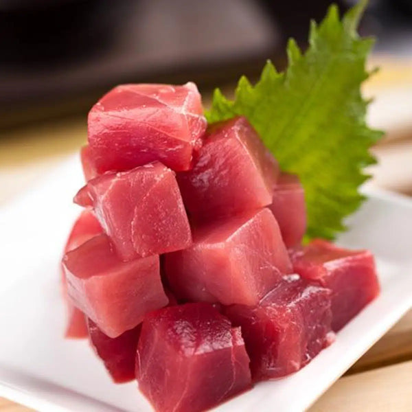Colorful poke bowl featuring diced ahi tuna, avocado, cucumber, and rice, garnished with sesame seeds and green onions, embodying a fusion of fresh flavors