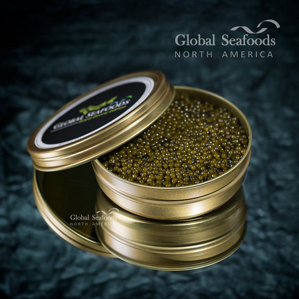 Premium Osetra sturgeon caviar with golden amber pearls served on a mother-of-pearl spoon