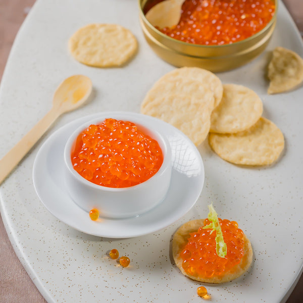 Bright orange trout caviar pearls served chilled for appetizers and entertaining
