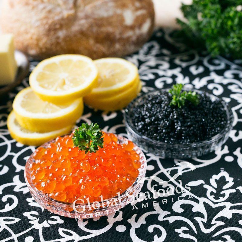 Elegant display of our Premium Caviar Collection, featuring select tins of Beluga, Ossetra, and Kaluga caviar, beautifully presented on a bed of ice with garnishes, embodying luxury and gourmet taste