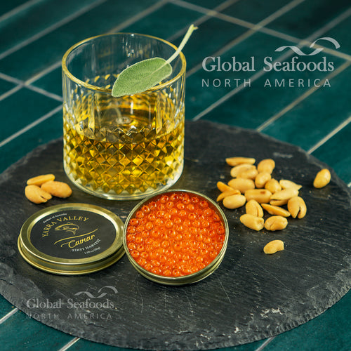 Close-up of vibrant orange Atlantic Salmon Roe in a tin, showcasing its firm pearls and fresh quality