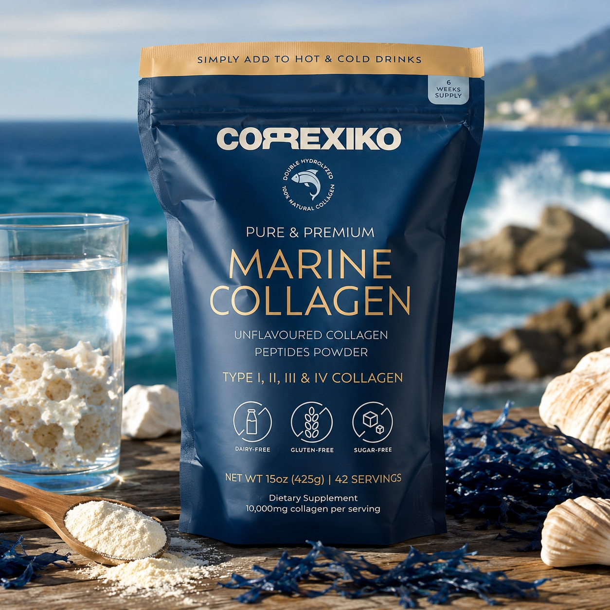 A stand-up pouch of CoprexiKO Marine Collagen peptides powder is photographed on a wooden surface with the ocean and rocks in the background. A glass of water, shells, seaweed, and a spoonful of white powder are arranged around it, making this a lifestyle product shot rather than a plain studio packshot.