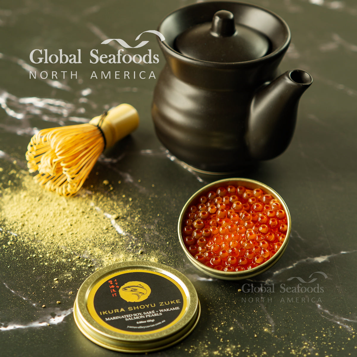 Ikura Shoyu Zuke salmon roe in an open tin beside a black teapot and bamboo whisk