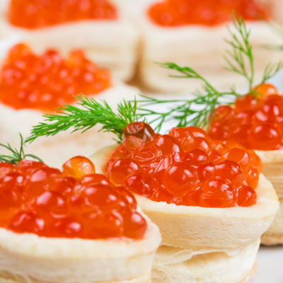 Red caviar from Atlantic salmon served on canapés, elegantly arranged for a gourmet appetizer presentation