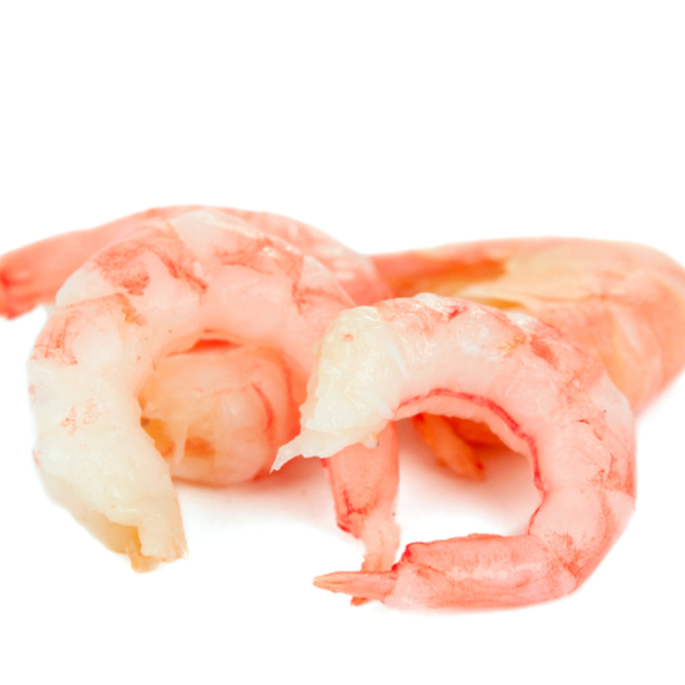 Defrosted Pacific pink shrimp meat, peeled and ready to eat, also known as salad shrimp, displayed on a clean surface