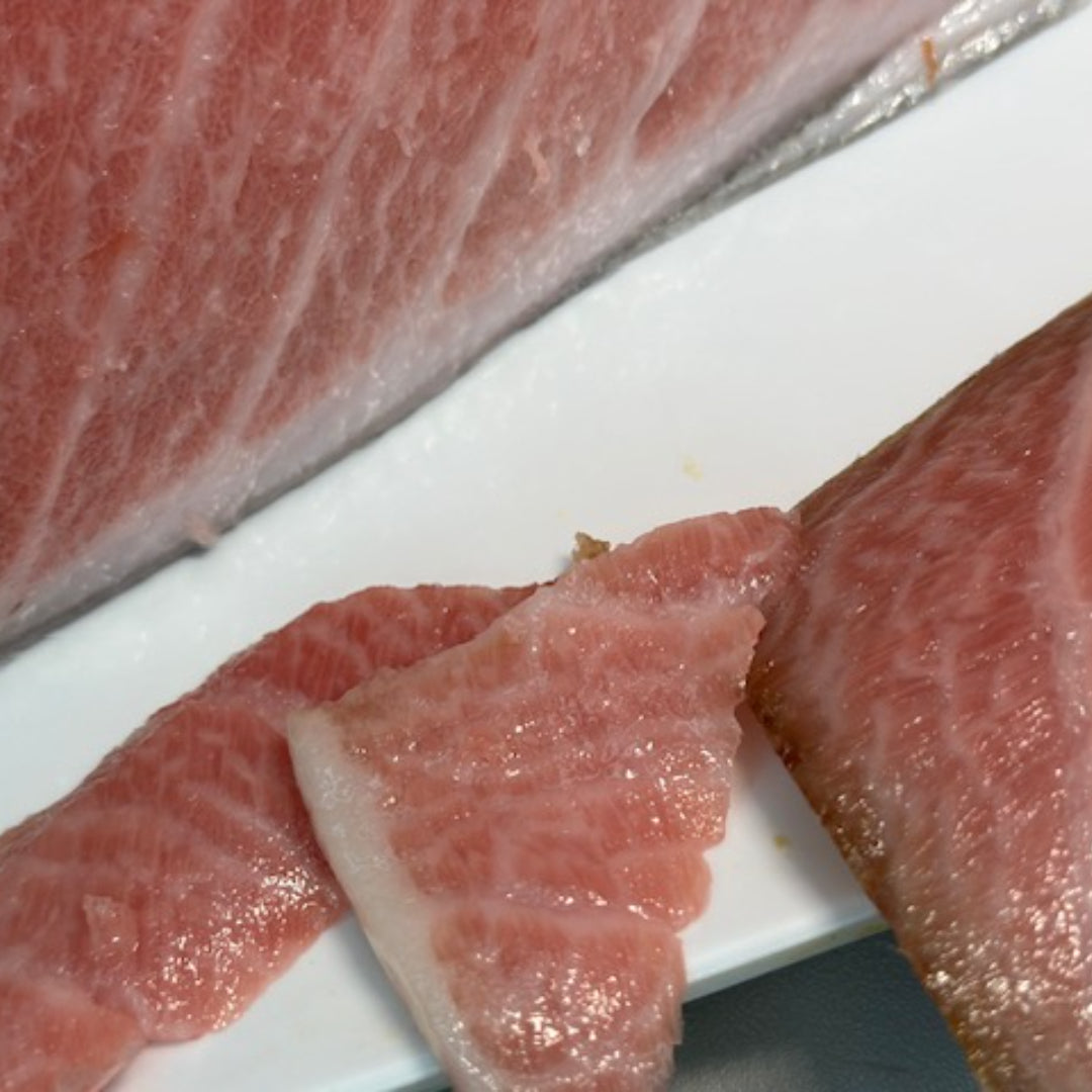 Dry-aged Bluefin toro with a buttery texture and vibrant red hue, arranged for gourmet presentation or sashimi serving