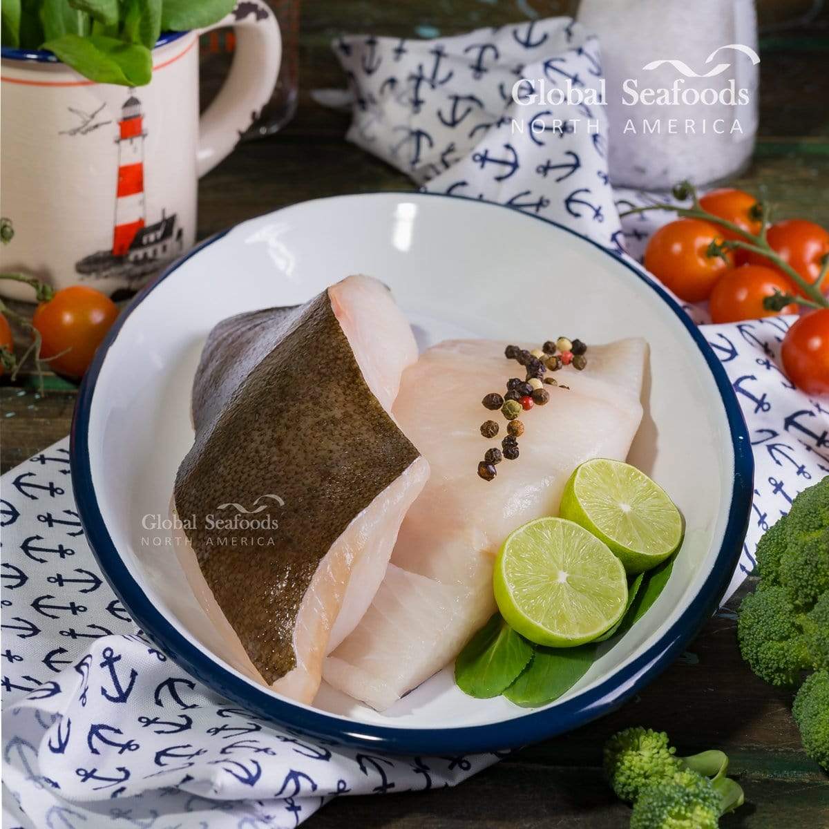 Skin-on halibut fillets on a white plate with lime slices and peppercorns.