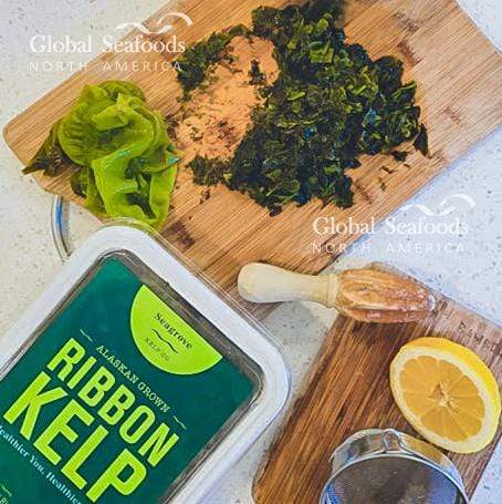 Fresh kelp laid out on a cutting board next to its plastic container, highlighting its natural texture and kitchen-ready presentation