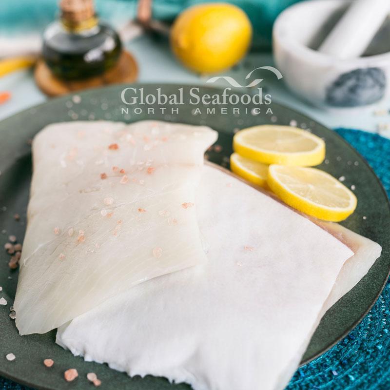 Fresh Pacific halibut fillet portion on ice, showcasing its natural, pristine quality