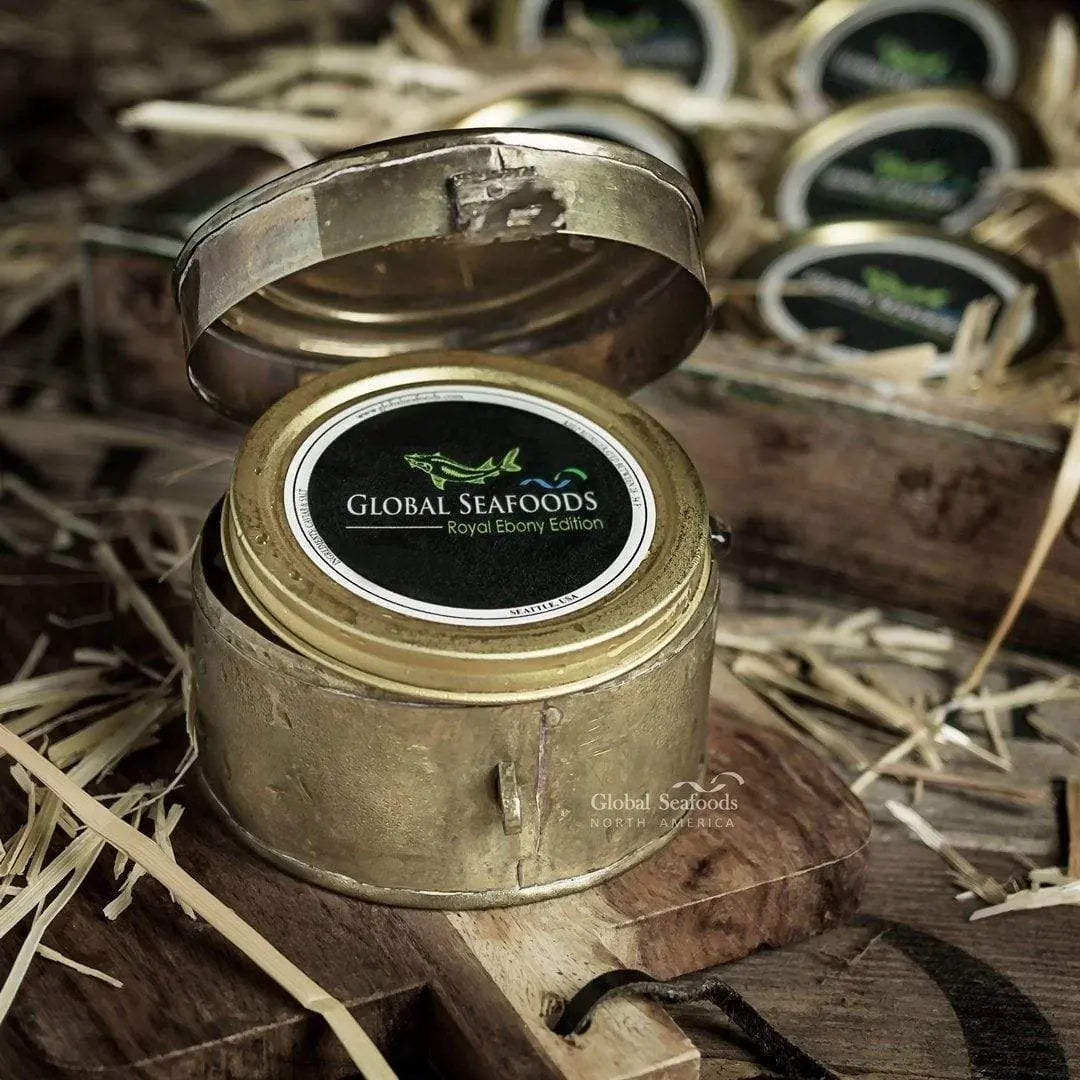 Closed Global Seafoods caviar tin inside an open metal presentation case with other tins in the background