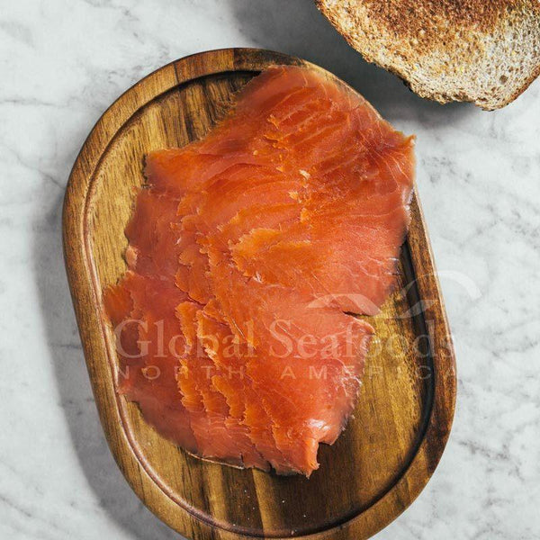 Cold-smoked Coho Salmon Nova Lox vacuum-sealed and ready for delivery, showcasing its rich color and freshness